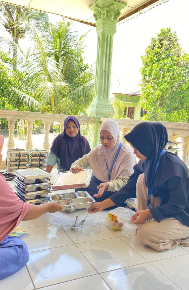 Keterangan Foto: Mahasiswa KKN IAIN Langsa bersama Ibu-Ibu PKK dan Ibu Kader Posyandu membagikan makanan bergizi gratis kepada anak-anak dan balita di Dusun Karang Sari, Kabupaten Langkat.