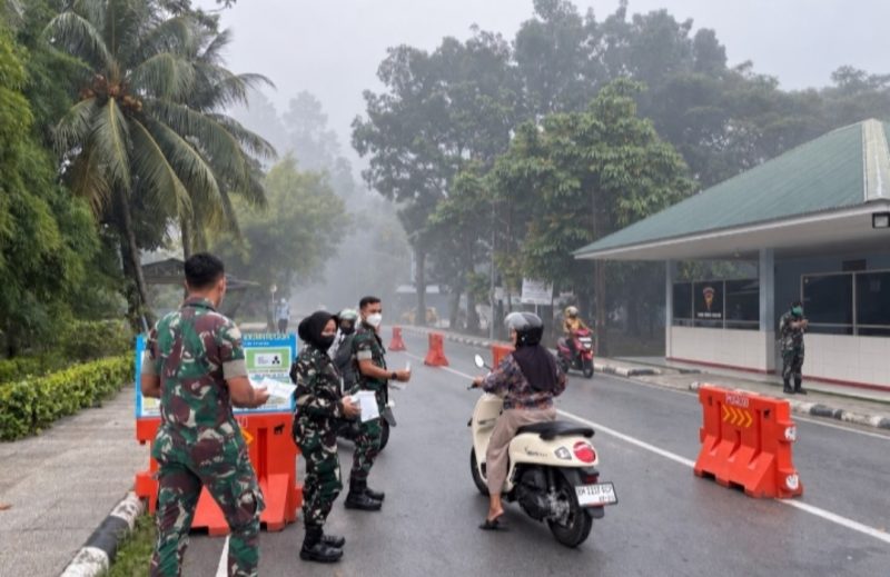 Keterangan foto: Personel TNI AU membagikan masker kepada masyarakat di depan gerbang masuk Lanud Roesmin Nurjadin, Pekanbaru.(dok.ist) 